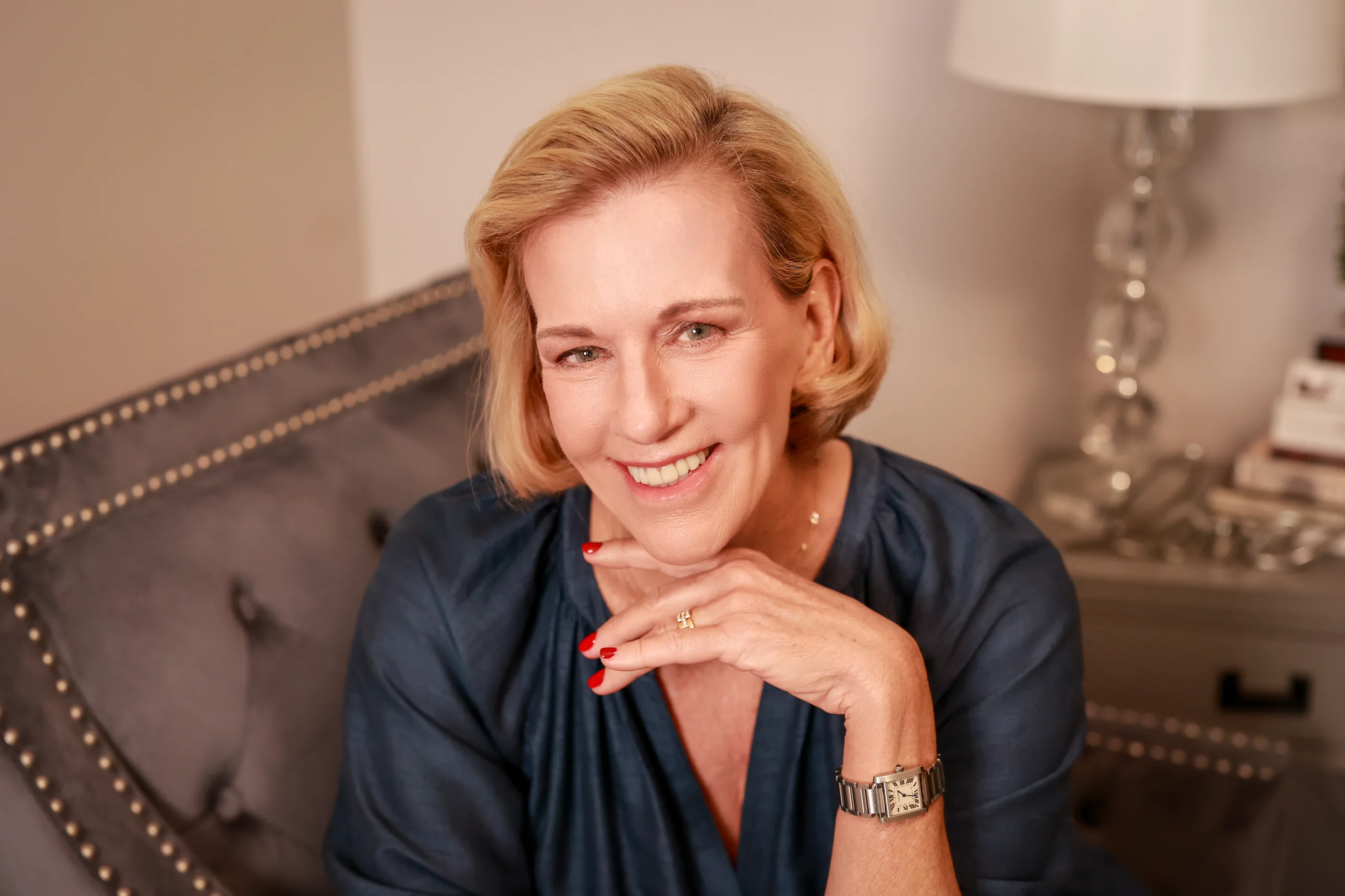 Portrait of Leslie Lacin, seated in an armchair with a warm smile